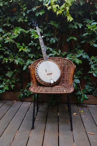 architecture shallow focus photo banjo on brown wicker chair building